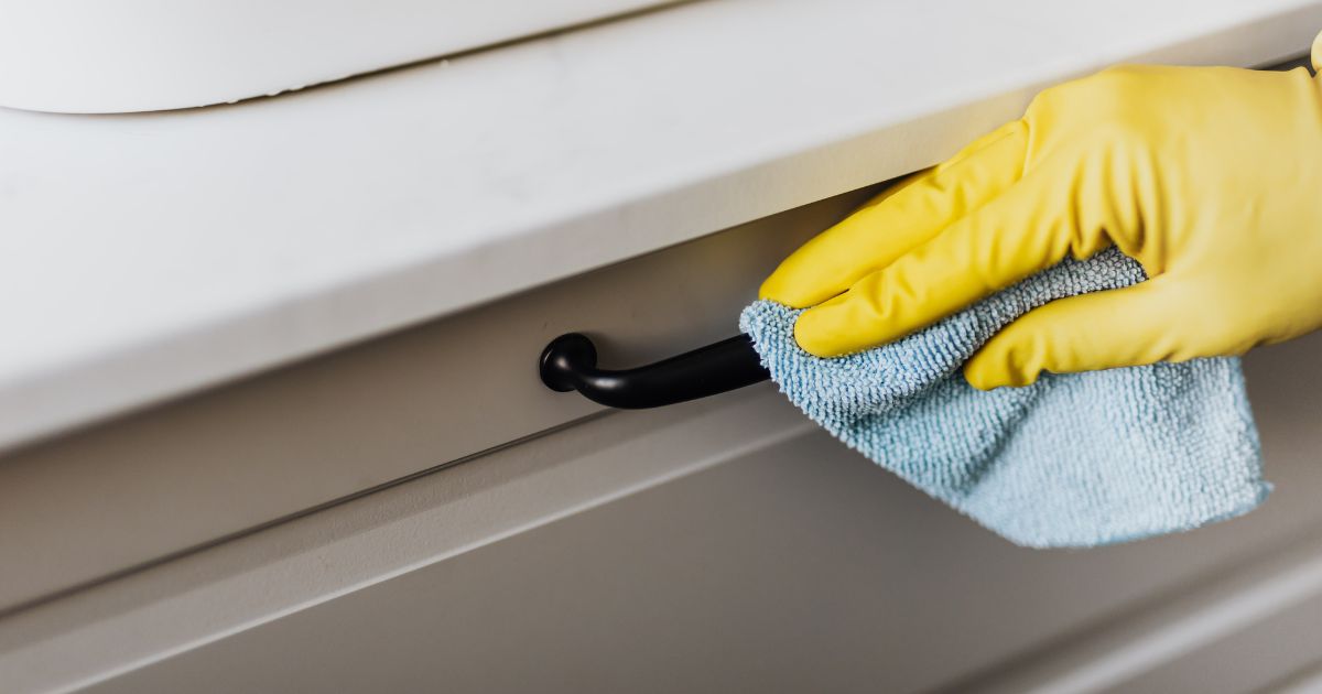 Person cleaning a drawer